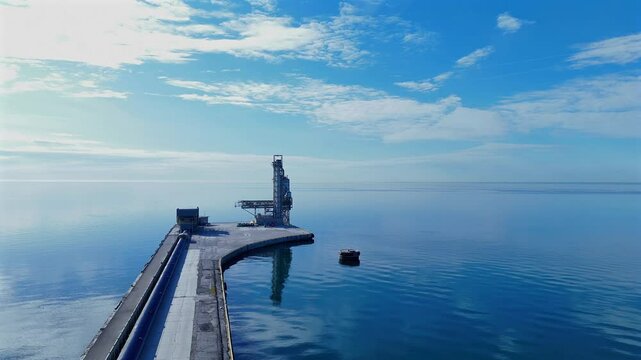 Flying over Gas transfer tower and Pier on lake ontario.