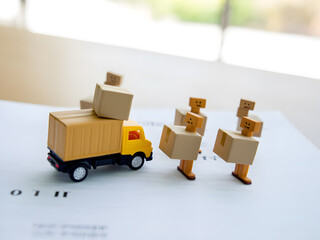 Delivery and Moving Scene With Boxes, Truck, and Miniature Figures. A playful scene with a toy truck, stacked boxes, coins, and tiny figures depicting moving, delivery, and logistics. Ideal for themes