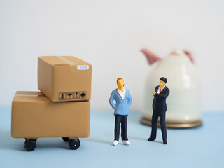 Delivery and Moving Scene With Boxes, Truck, and Miniature Figures. A playful scene with a toy truck, stacked boxes, coins, and tiny figures depicting moving, delivery, and logistics. Ideal for themes