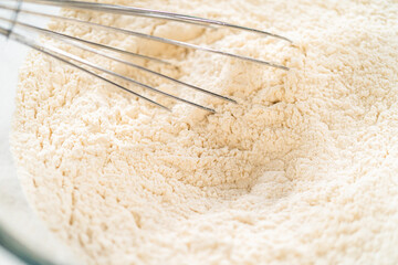 Whisk Mixing Flour in Glass Bowl