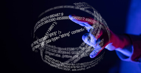 Futuristic image of a hand interacting with a digital sphere filled with code and data.