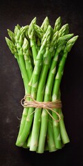 Fresh green asparagus bunch on dark rustic background