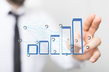 Stock photo of a hand interacting with a 3D bar chart, illustrating data analysis and business...