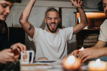 People enjoying a game night at home, showcasing emotions of happiness, victory, and camaraderie in a relaxed and warm atmosphere.