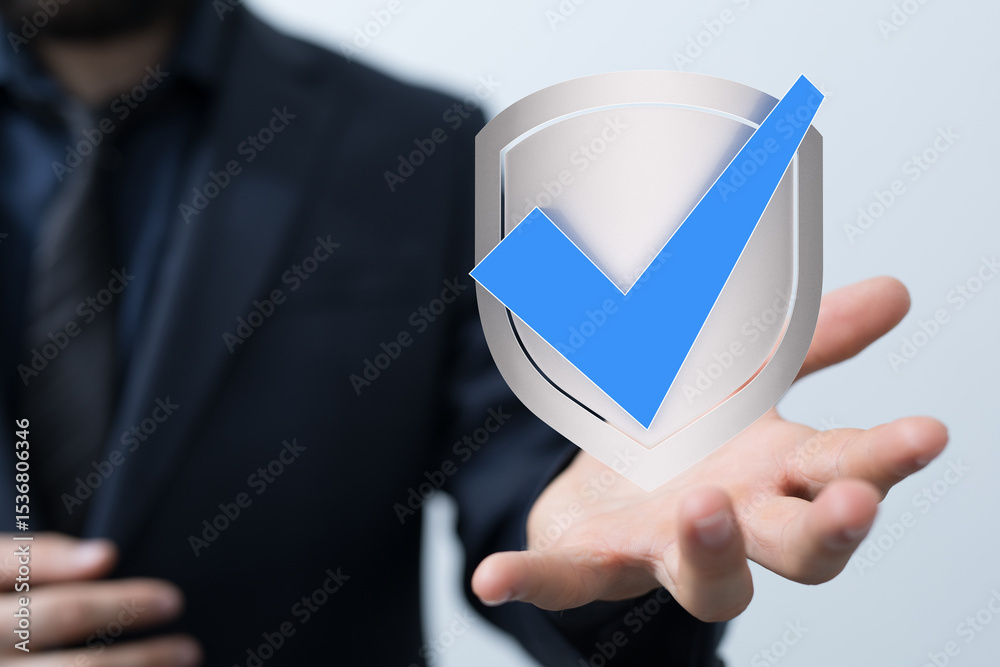 Poster image of a businessman holding a digital shield with a checkmark, symbolizing security and approval.