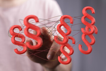 Abstract image of red paragraph symbols interconnected, symbolizing legal connections and...
