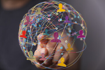 Stock photo of a hand interacting with a global network visualization.  Represents connection,...