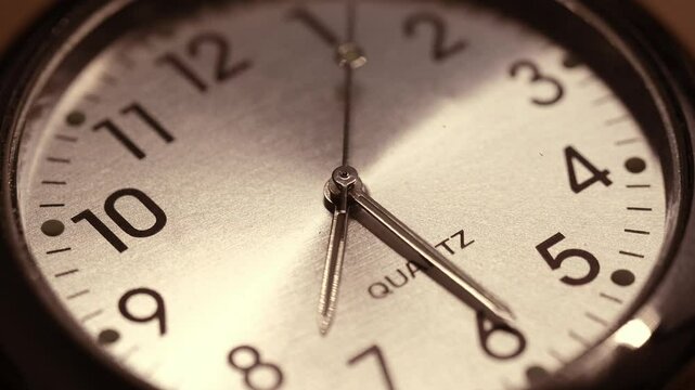 A detailed close-up video of a vintage-style quartz A close-up video of a vintage-style quartz clock face, highlighting the smooth movement of hands and the passage of time.