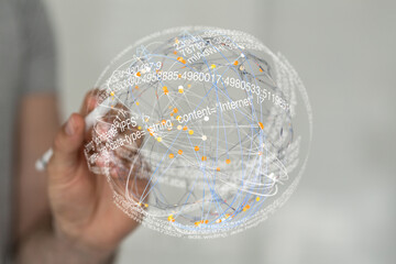 Abstract image depicting a hand interacting with a digital sphere representing global data...