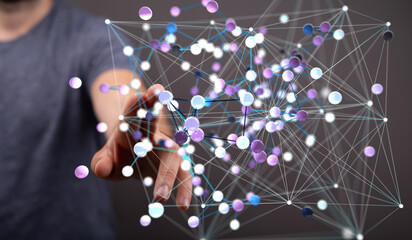 Abstract image of a hand interacting with a complex network of interconnected nodes, representing...