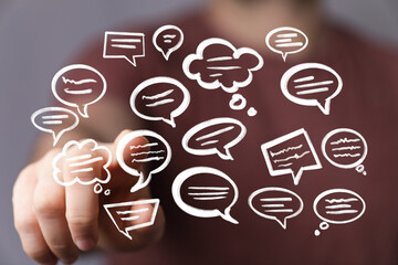 Hand interacting with floating speech bubbles,communication, conversation, feedback concept.