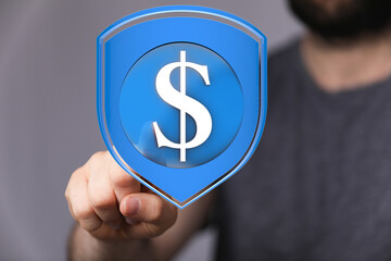 Financial security concept.  A hand interacts with a digital shield protecting a dollar sign.