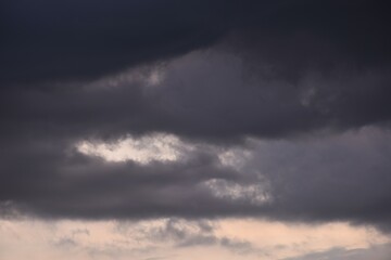 dark rain cloud floating on sky at sunset in evening