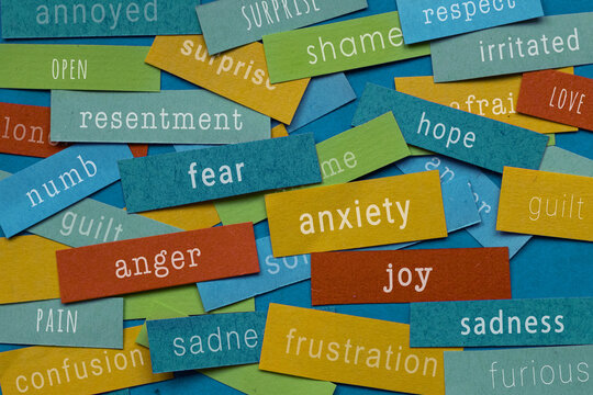 different emotions and feelings written on colorful papers - anxiety, anger, joy, sadness, emotional intelligence and mental health