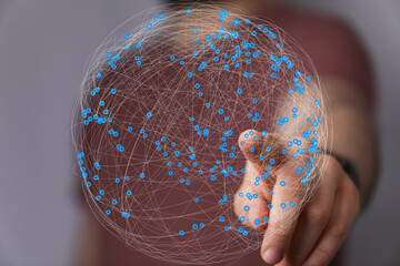 Abstract image of a hand interacting with a digital sphere representing global network connections.