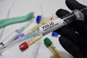 Polio vaccination drug syringe in black gloved hands. Medical concept