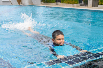 Teenage boy ready to swim in swimming pool