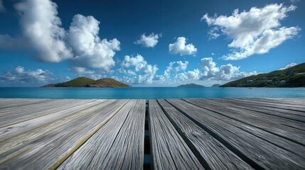 Gray wooden pier overlooking a tranquil island sea.