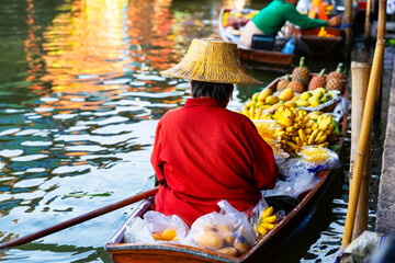 Traditional floating market in Damnoen Saduak near Bangkok in Thailand. Fruit seller at Damnoen Saduak floating market.