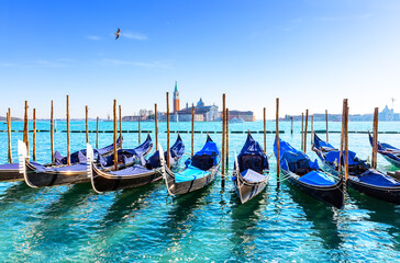 Gondolas on the Grand canal in Venice, Italy. In background, on island of San Giorgio, is the Church of San Giorgio Maggiore with bell tower.