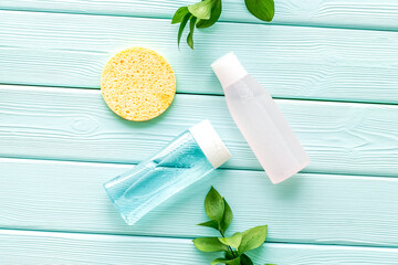 Organic cosmetics for face clearing with sponge, facial tonic, mycelial water on mint green background top view mockup