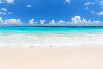Summer vacation at a beautiful white sand beach and turquoise sea in Punta Cana Dominican Republic. Summer beach holiday concept.