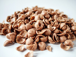 Chocolate cereals corn flakes on white background
Cornflakes pile for breakfast, heap of brown...
