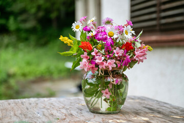 Beautiful bouquet of summer wild flowers in a green garden