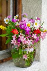 Beautiful bouquet of summer wild flowers in a green garden