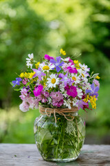 Beautiful bouquet of summer wild flowers in a green garden
