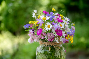 Beautiful bouquet of summer wild flowers in a green garden