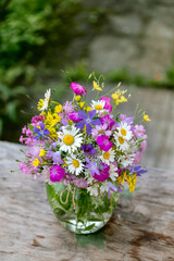 Beautiful bouquet of summer wild flowers in a green garden