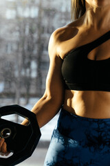 sport woman does exercises at the gym 