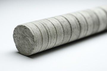 Concrete cylinder showcasing textured surface in industrial setting for construction materials