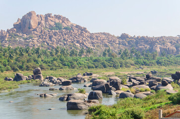 Tungabhadra river in the village of Hampi, Big stones, Exotic landscape, Hampi, Karnataka, India.