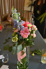 Finished flower bouquets created during the workshop are displayed in a vase.








