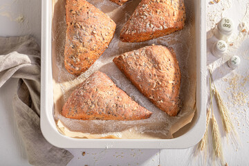 Tasty and homemade triangular rolls in rustic bakehouse.