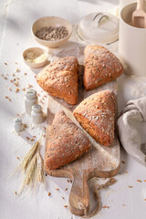Tasty and brown triangular rolls in rustic bakehouse.