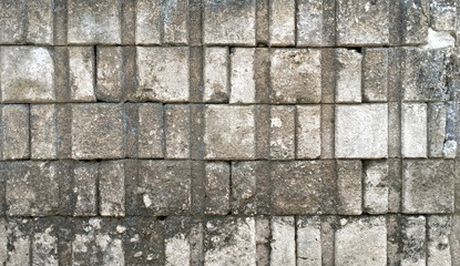 Old brick walls arranged in an orderly manner There are dirt stains on the bricks that have an uneven surface.