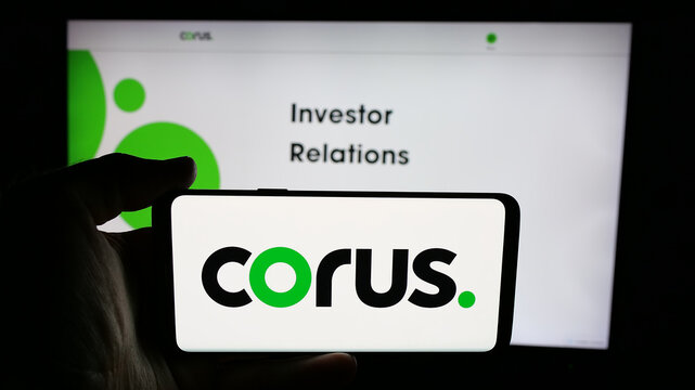 Stuttgart, Germany - 06-09-2025: Person holding cellphone with logo of media company Corus Entertainment Inc. on screen in front of webpage. Focus on phone display.