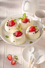 Tasty and homemade monoportion cheesecake with strawberries and sprinkles.