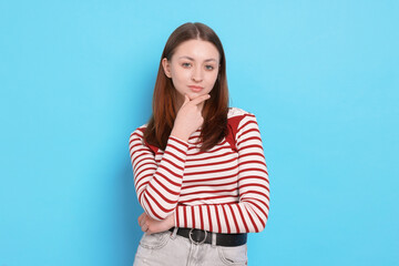 Portrait of teenage girl on light blue background
