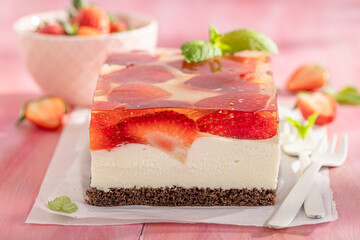 Homemade and sweet strawberry cheesecake with vanilla cream and jelly.