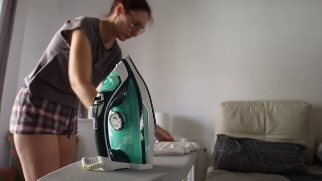 Woman ironing clothes at home, a step by step guide
