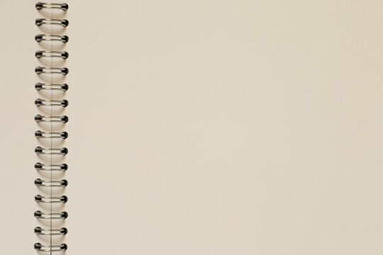 close up of blank page of sketchbook with metal spiral binder - Powered by Adobe