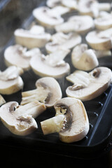 Sliced ​​champignons on an electric grill, mushrooms.