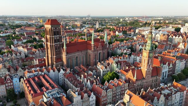 Aerial video shot by drone over the historic tourist center of Gdansk, the city hall and the cathedral on a summer day, Poland, Europe