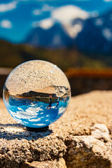 Crystal ball alpine spring landscape shot with Mount Wilder Kaiser in the background at Kaiserlift Kufstein, Tyrol, Austria
