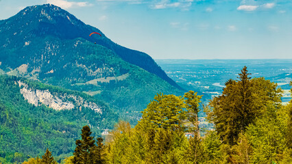 Alpine spring view with a paraglider at Kaiserlift Kufstein, Tyrol, Austria