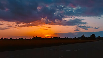 Spring sunset or sundowner view with a church and dramatic clouds near Langenisarhofen, Moos, Deggendorf, Bavaria, Germany